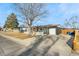 View of home with attached garage, picket fence, and well-kept lawn at 5116 Jellison St, Arvada, CO 80002