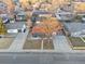 Overhead angle captures the home's landscaped front yard, driveway, and peaceful neighborhood setting at 5116 Jellison St, Arvada, CO 80002