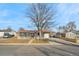 Inviting single-story home with neat front yard, white picket fence, and a large mature tree at 5116 Jellison St, Arvada, CO 80002