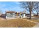 Inviting single-story home with a cozy front yard, complemented by a charming white picket fence at 5116 Jellison St, Arvada, CO 80002