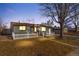Charming single story home features a well kept front yard with white picket fence and mature tree at 5116 Jellison St, Arvada, CO 80002