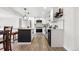 Tastefully remodeled kitchen featuring white cabinets, quartz countertops, and modern fixtures, complete with a cozy dining area at 5116 Jellison St, Arvada, CO 80002