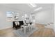 Bright living room boasts natural light with light-colored floors, a black futon, and a decorative rug at 5116 Jellison St, Arvada, CO 80002