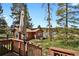 Exterior view from the deck to the backyard of the house, showing an expansive lawn at 9359 Barnes Ave, Conifer, CO 80433