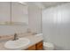 Clean bathroom with a modern vanity, neutral tiles, and a shower-tub combination at 9359 Barnes Ave, Conifer, CO 80433
