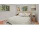Stylishly staged bedroom features neutral decor, natural light, and a modern aesthetic on top of gorgeous hardwood floors at 9359 Barnes Ave, Conifer, CO 80433