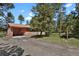 A single-Gathering home featuring a spacious driveway, lush lawn, and beautiful natural surroundings at 9359 Barnes Ave, Conifer, CO 80433