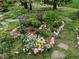 A colorful, flourishing garden features a variety of vibrant plants and stone accents at 9359 Barnes Ave, Conifer, CO 80433