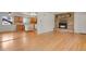 Inviting open-concept living space featuring hardwood floors and a charming brick fireplace at 9359 Barnes Ave, Conifer, CO 80433