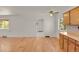 Sun-filled living room showcases hardwood floors and fresh white paint, with an adjacent kitchen and an open floorplan at 9359 Barnes Ave, Conifer, CO 80433