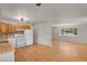 Open floor plan blending the kitchen and living room, features hardwood floors and a neutral color palette at 9359 Barnes Ave, Conifer, CO 80433