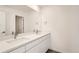 Modern bathroom with double vanity sinks, a large mirror, and updated fixtures at 1296 S Algonquian, Aurora, CO 80018