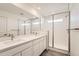 Sleek bathroom with double sink vanity, glass-enclosed shower, and modern finishes at 1296 S Algonquian, Aurora, CO 80018