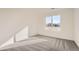 Bright bedroom featuring neutral carpet and a large window offering neighborhood views at 1296 S Algonquian, Aurora, CO 80018