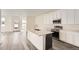 Modern kitchen featuring white cabinets, stainless steel appliances, and a large island at 1296 S Algonquian, Aurora, CO 80018