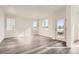 Bright and airy living room with modern gray laminate flooring and ample natural light at 1296 S Algonquian, Aurora, CO 80018