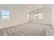 Spacious main bedroom featuring neutral carpet, tray ceilings, and plenty of natural light at 1296 S Algonquian, Aurora, CO 80018