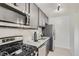 Stylish kitchen with gray cabinetry, stainless steel appliances, and ample counter space at 2100 N Franklin St # 20, Denver, CO 80205
