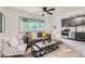 Airy living room features a gray sofa, accent pillows, large window, and modern decor at 2100 N Franklin St # 20, Denver, CO 80205