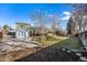 Backyard showcasing a deck, shed, and spacious lawn at 1539 S Quail St, Denver, CO 80232