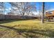 Expansive, grassy backyard with mature trees and a privacy fence at 1539 S Quail St, Denver, CO 80232