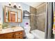 Cozy bathroom with a tub-shower combination, a vanity with a sink, and tiled walls at 1539 S Quail St, Denver, CO 80232