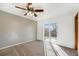 Serene bedroom with a ceiling fan, walk-out to balcony, and natural light at 1539 S Quail St, Denver, CO 80232