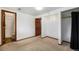 Bedroom with view to bathroom featuring carpet flooring and natural light at 1539 S Quail St, Denver, CO 80232