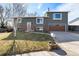 Charming two-story home with a well-maintained lawn and attached two-car garage in a quiet neighborhood at 1539 S Quail St, Denver, CO 80232