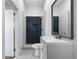 Modern bathroom with dark-tiled shower and updated vanity at 4442 Josephine St, Denver, CO 80216