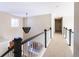 Upstairs hallway with chandelier and view of living area at 5110 S Logan Dr, Greenwood Village, CO 80121