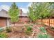 Landscaped backyard with a stone pathway and a wooden bench at 730 Cook St, Denver, CO 80206