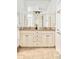 Bathroom featuring a double sink vanity, granite countertops, and decorative hardware at 730 Cook St, Denver, CO 80206