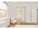 Bright bedroom featuring a chair, storage, and an open doorway to another room, offering style and convenience at 730 Cook St, Denver, CO 80206