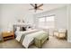Cozy bedroom with neutral decor, large window, ceiling fan and hardwood floors at 730 Cook St, Denver, CO 80206