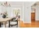 Charming dining room features hardwood floors, bright windows, and seamlessly connects to living area at 730 Cook St, Denver, CO 80206