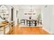 Formal dining room featuring modern light fixture, wood floors, and bright windows at 730 Cook St, Denver, CO 80206