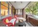 Charming front porch with comfortable wicker seating, brick accents, and outdoor charm at 730 Cook St, Denver, CO 80206