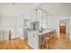 Spacious kitchen featuring a center island with bar seating, granite countertops, and hardwood flooring at 730 Cook St, Denver, CO 80206