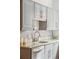 Kitchen with gray cabinetry, stainless steel appliances, granite countertops and tile backsplash at 730 Cook St, Denver, CO 80206