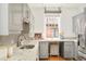 Well-lit kitchen featuring granite countertops, gray cabinetry, and stainless steel appliances at 730 Cook St, Denver, CO 80206
