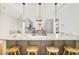 Open-concept kitchen with a granite island, seating, stainless steel appliances, and gray cabinetry at 730 Cook St, Denver, CO 80206