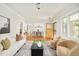 Open-concept living area with hardwood floors, a fireplace and a smooth transition to the dining room at 730 Cook St, Denver, CO 80206