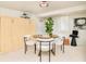 Cozy living room features a murphy bed and a table set with seating for four at 730 Cook St, Denver, CO 80206