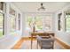 Bright office space featuring large windows, hardwood floors, and a vintage-style desk and chair at 730 Cook St, Denver, CO 80206