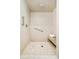 Walk-in shower with neutral tiles, bench, grab bar, and showerhead at 730 Cook St, Denver, CO 80206