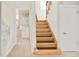 Staircase leading up from an entrance hall with an adjacent view into a bathroom at 730 Cook St, Denver, CO 80206