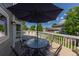 Charming back deck with a table, chairs, and shade umbrella, creating an ideal outdoor dining spot at 1881 Alma Ln, Superior, CO 80027