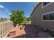 Inviting backyard patio with red stone tiling, built-in benches, and a charming fire pit for outdoor relaxation and entertaining at 1881 Alma Ln, Superior, CO 80027