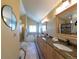 Bright bathroom featuring double sinks, granite countertops, soaking tub and stylish tile flooring at 1881 Alma Ln, Superior, CO 80027
